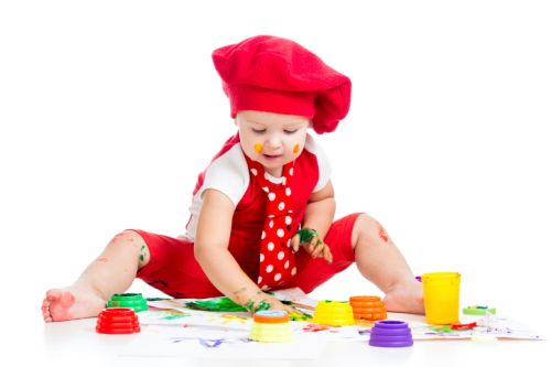 small artist child painting with finger