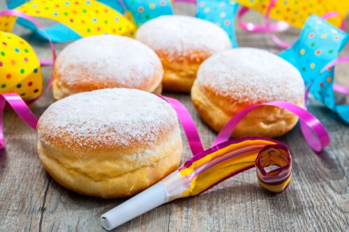 Krapfen or donuts with jam and icing sugar